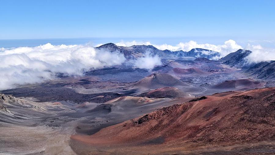 A beautiful shot of Haleakala National Park overlooking mountains and dormant volcano craters in Maui, Hawaii.